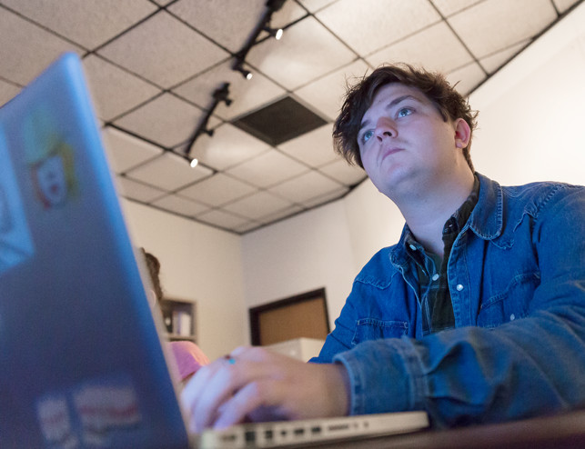 ORU design student on computer.